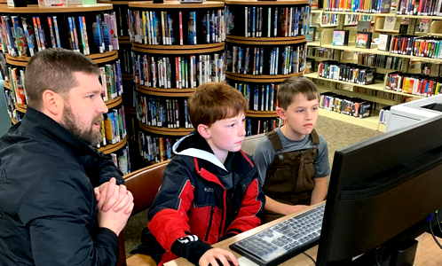 Ben Hayes teaching coding to 2 boys