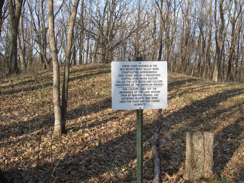 Picture of one the Indian burial mounds at the Skillet Creek with sign in the foreground describing it.